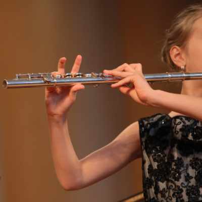 Child playing flute in Music Society Victoria concert