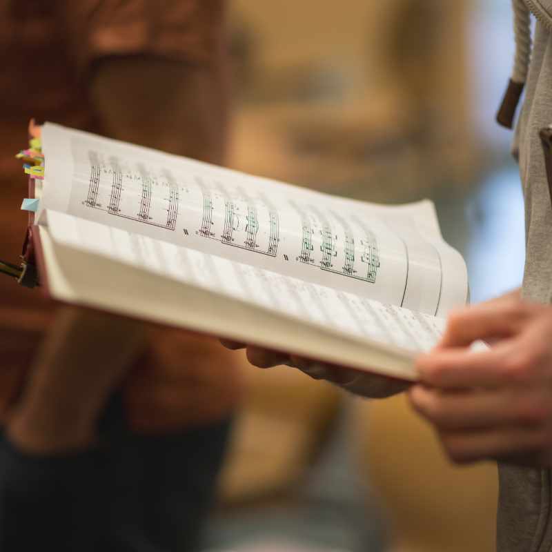 Male singer holding music in Star Chorale rehearsal