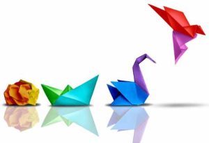 scrunched piece of paper progressing to origami bird